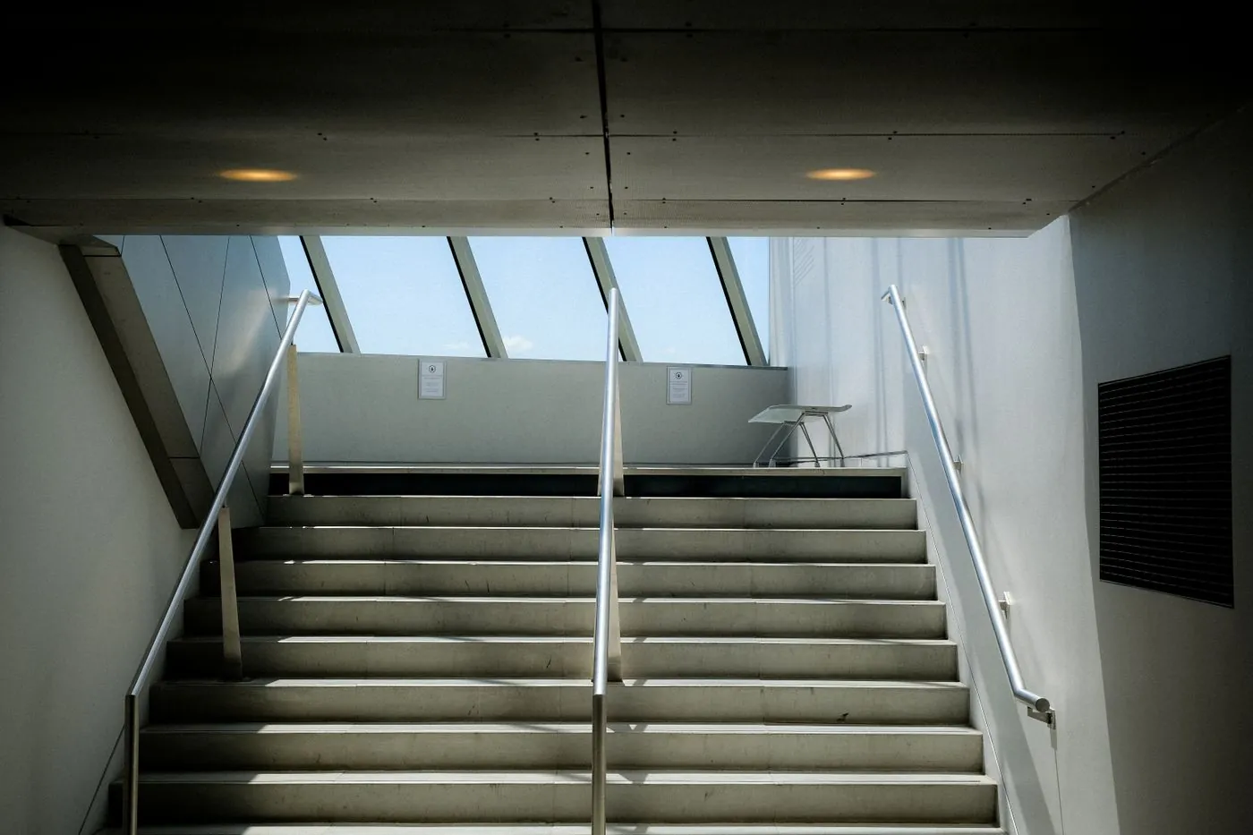 A concrete staircase lit from above