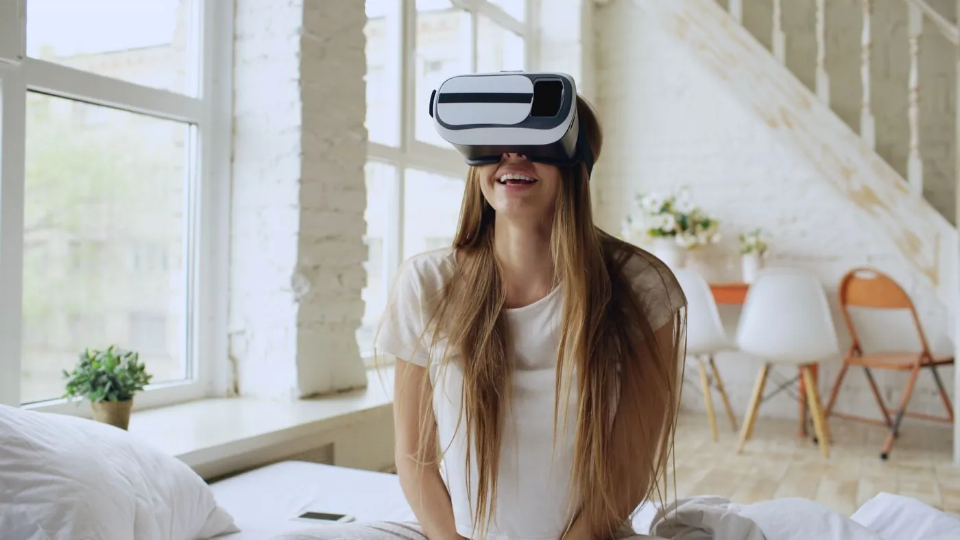 A woman wearing a VR headset in a bright room